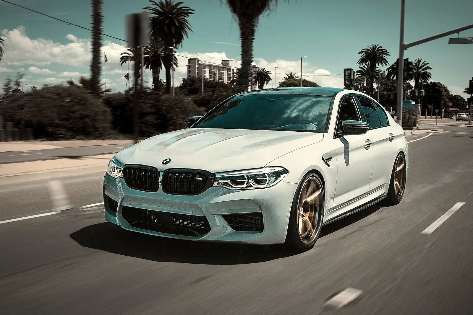 White executive sedan on a city street